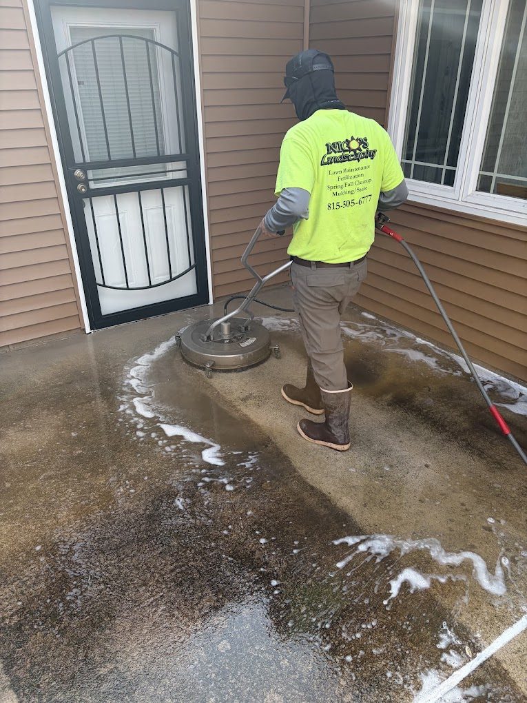 Nico's crew member surface cleaning a concrete patio
