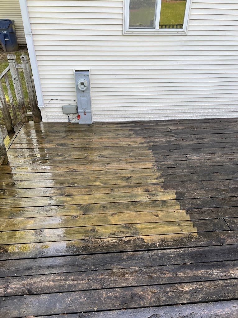 Wood deck mid-clean showing the dramatic difference between washed and unwashed boards